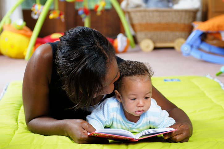 Storytime on the playmat with mother and baby in an indoor setting